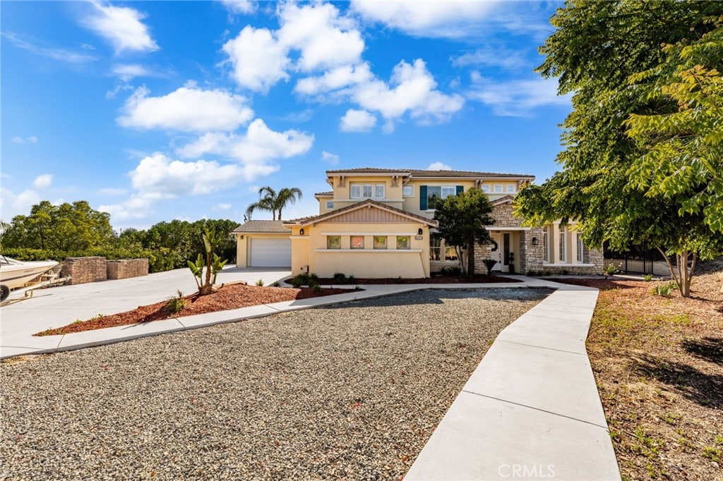 18660 Sunset Knoll Dr, Riverside, CA 92504 - view of front of house featuring concrete driveway, stucco siding, and stone siding