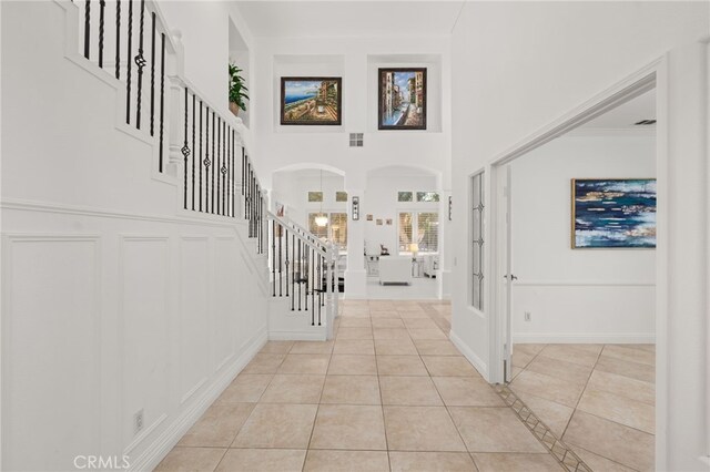 18660 Sunset Knoll Dr, Riverside, CA 92504 - foyer with stairway, light tile patterned floors, arched walkways, french doors, and a decorative wall