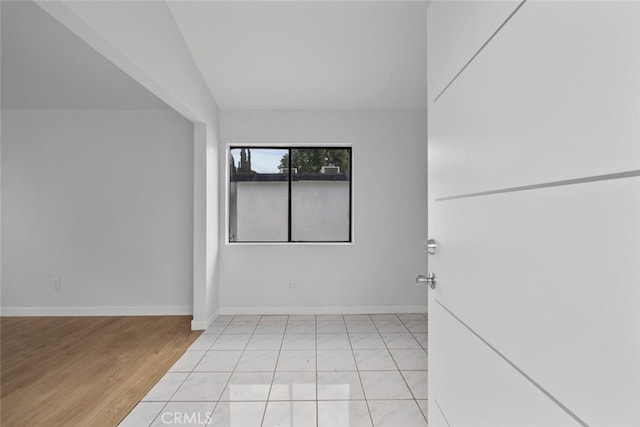 11177 Tamarack Ave, Pacoima, CA 91331 - unfurnished room featuring baseboards, light wood-type flooring, and lofted ceiling