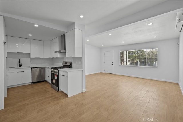 11177 Tamarack Ave, Pacoima, CA 91331 - kitchen with appliances with stainless steel finishes, wall chimney exhaust hood, modern cabinets, a sink, and white cabinetry