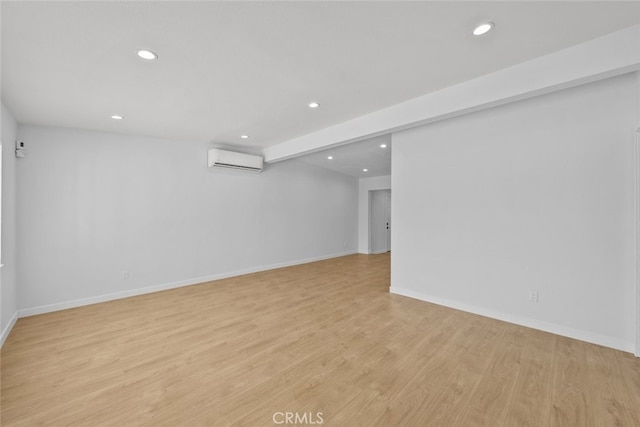 11177 Tamarack Ave, Pacoima, CA 91331 - finished below grade area featuring recessed lighting, an AC wall unit, light wood-style floors, and baseboards
