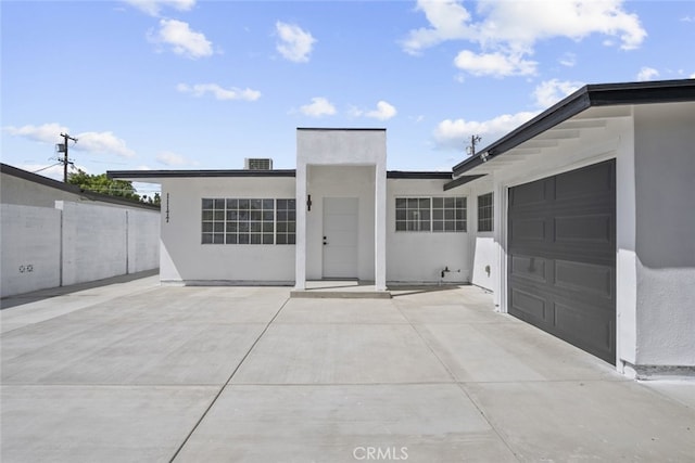 11177 Tamarack Ave, Pacoima, CA 91331 - view of front of house featuring stucco siding, fence, and a garage