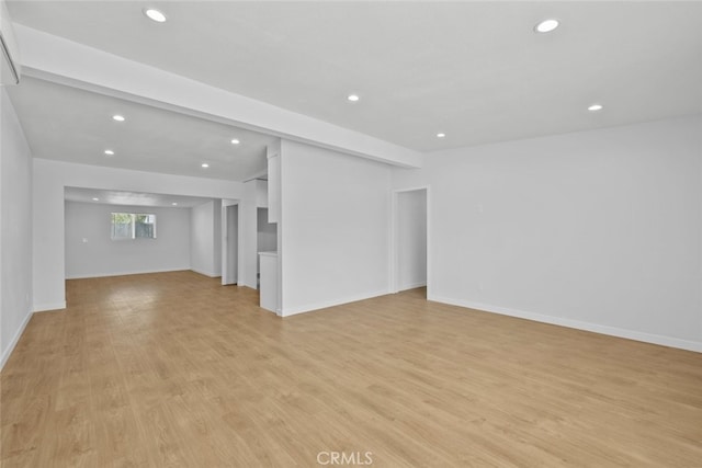 11177 Tamarack Ave, Pacoima, CA 91331 - unfurnished living room with recessed lighting, light wood-style flooring, and baseboards