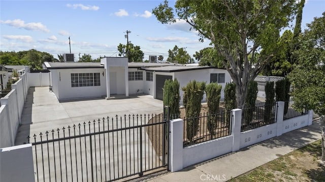 11177 Tamarack Ave, Pacoima, CA 91331 - view of front facade featuring stucco siding, concrete driveway, a fenced front yard, and an attached garage