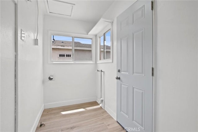 5939 5th Ave, Hyde Park, CA 90043 - laundry room featuring baseboards, light wood-style floors, and attic access