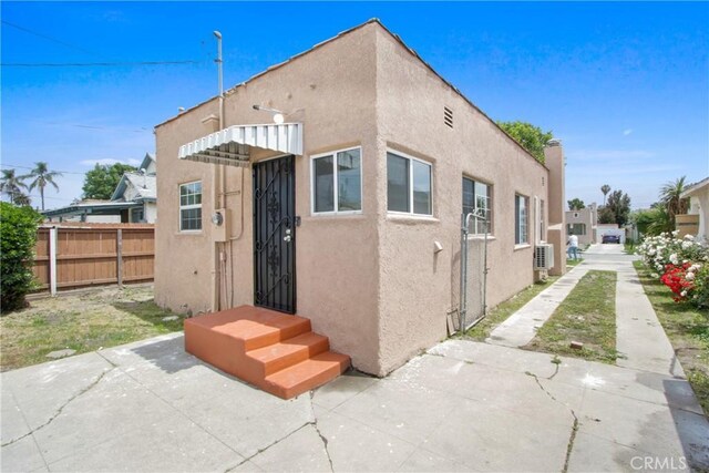 5939 5th Ave, Hyde Park, CA 90043 - back of property with fence and stucco siding