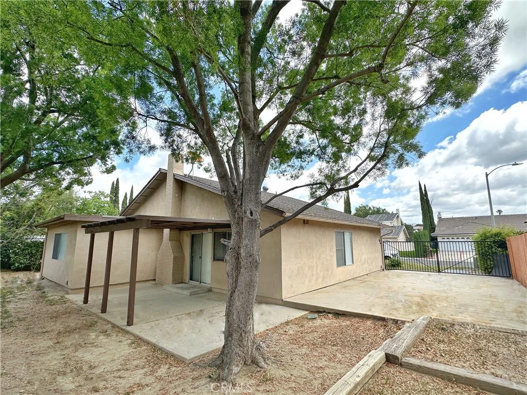 rear view of property with a patio and stucco siding