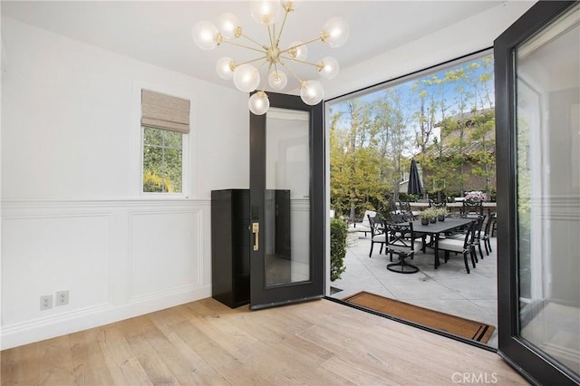 6 Shively Rd, Ladera Ranch, CA 92694 - entryway with a chandelier, a decorative wall, wood finished floors, and wainscoting
