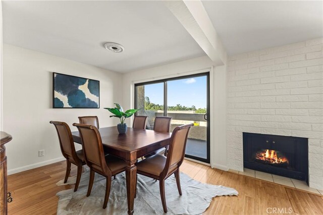 4227 Freedom Dr Unit 304, Calabasas, CA 91302 - dining room featuring light wood-type flooring, baseboards, and a large fireplace