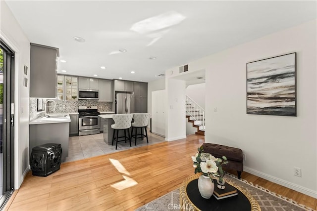 4227 Freedom Dr Unit 304, Calabasas, CA 91302 - living room featuring stairway, light wood-type flooring, baseboards, and recessed lighting