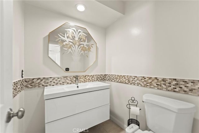 4227 Freedom Dr Unit 304, Calabasas, CA 91302 - bathroom featuring toilet, vanity, tile walls, tile patterned floors, and wainscoting