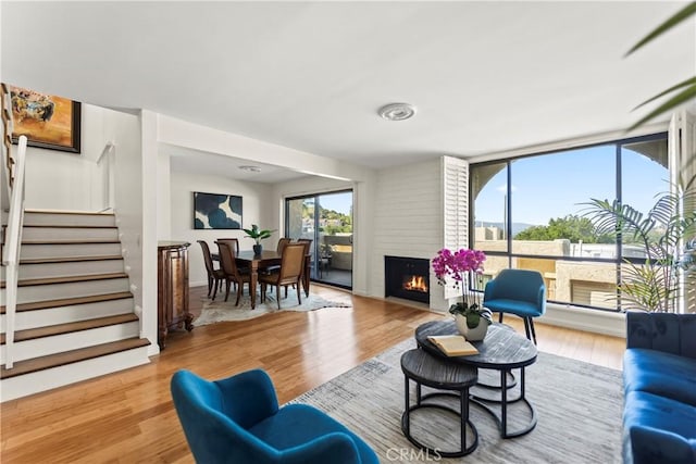 4227 Freedom Dr Unit 304, Calabasas, CA 91302 - living room featuring light wood finished floors, stairs, and a large fireplace
