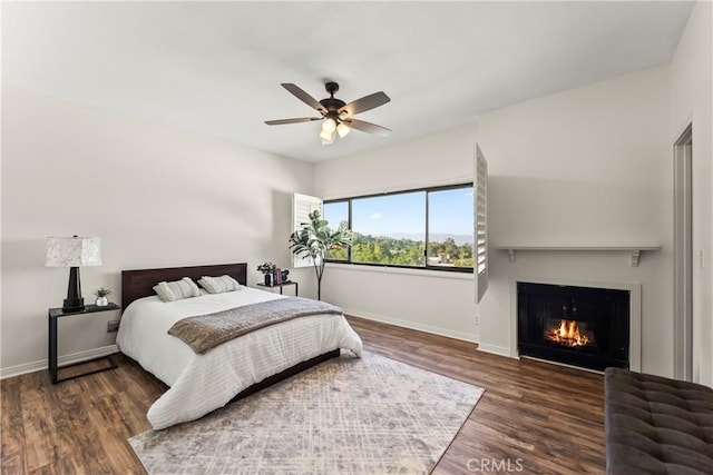 4227 Freedom Dr Unit 304, Calabasas, CA 91302 - bedroom with baseboards, wood finished floors, a warm lit fireplace, and a ceiling fan