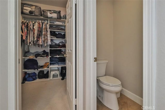 536 Granite Hills St, Simi Valley, CA 93065 - bathroom with toilet, a spacious closet, tile patterned flooring, and baseboards