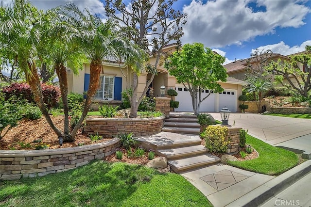 536 Granite Hills St, Simi Valley, CA 93065 - view of property hidden behind natural elements with driveway, a garage, and stucco siding