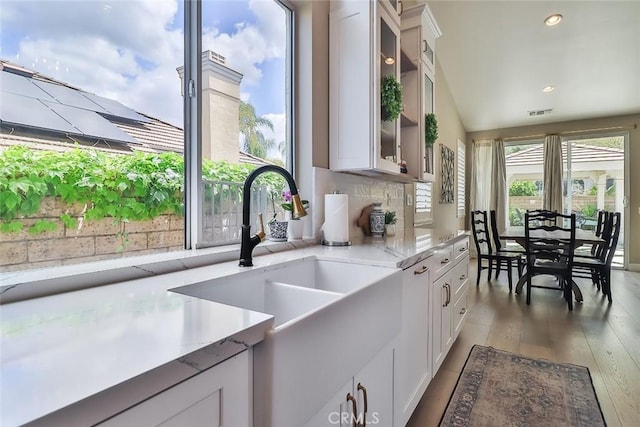 536 Granite Hills St, Simi Valley, CA 93065 - kitchen with a sink, hardwood / wood-style flooring, white cabinetry, glass insert cabinets, and light stone counters
