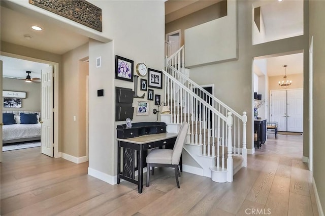 536 Granite Hills St, Simi Valley, CA 93065 - stairs with wood finished floors, a ceiling fan, baseboards, a chandelier, and a high ceiling