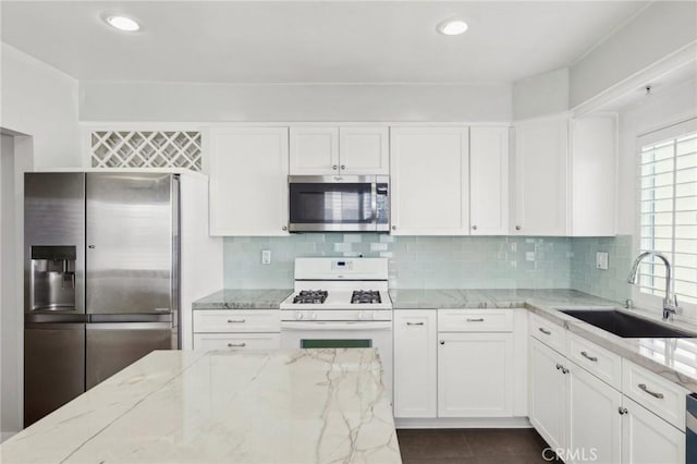 13220 Valleyheart Dr Unit 106, Studio City, CA 91604 - kitchen with appliances with stainless steel finishes, a sink, white cabinetry, light stone counters, and recessed lighting