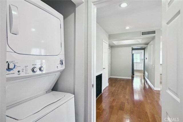 13220 Valleyheart Dr Unit 106, Studio City, CA 91604 - clothes washing area featuring stacked washer / drying machine, wood finished floors, baseboards, and recessed lighting