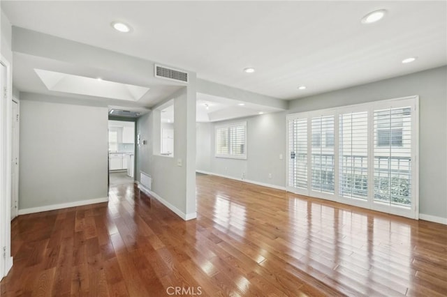 13220 Valleyheart Dr Unit 106, Studio City, CA 91604 - empty room featuring a skylight, baseboards, wood finished floors, and recessed lighting