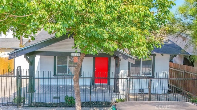 1327 Exposition Blvd, Los Angeles, CA 90018 - view of front of home with a porch, a fenced front yard, and a shingled roof