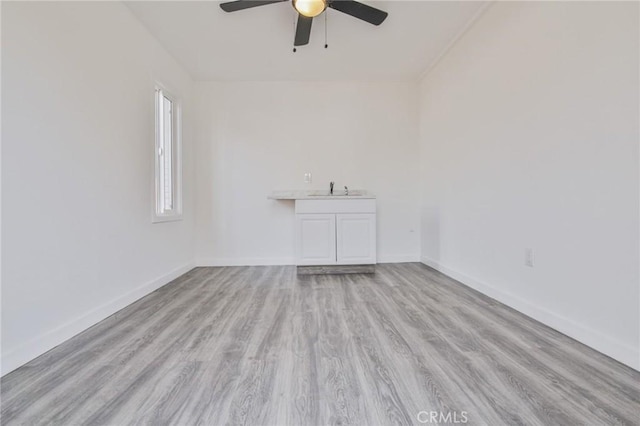 1327 Exposition Blvd, Los Angeles, CA 90018 - spare room with ceiling fan, wood finished floors, baseboards, and a sink