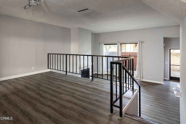 103 E Sierra Madre Blvd Unit E, Sierra Madre, CA 91024 - stairs featuring a textured ceiling, wood finished floors, and baseboards