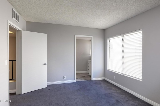 103 E Sierra Madre Blvd Unit E, Sierra Madre, CA 91024 - unfurnished bedroom with carpet, a textured ceiling, ensuite bath, and baseboards