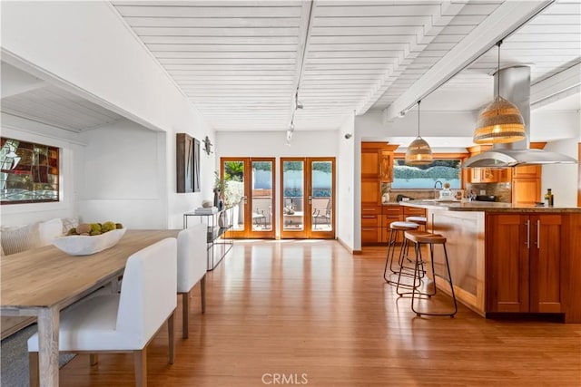 1961 San Remo Dr, Laguna Beach, CA 92651 - dining space featuring light wood finished floors, beamed ceiling, and french doors