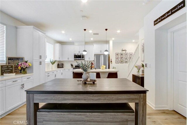 4085 E Liliana Paseo Unit 69, Ontario, CA 91764 - dining room featuring light wood finished floors, stairway, and recessed lighting