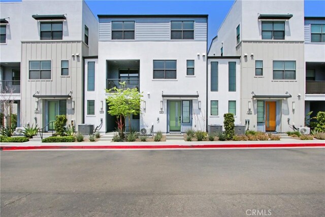 4085 E Liliana Paseo Unit 69, Ontario, CA 91764 - townhome / multi-family property with cooling unit, stucco siding, and board and batten siding