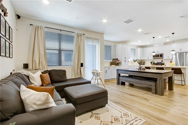 4085 E Liliana Paseo Unit 69, Ontario, CA 91764 - living room with light wood-style floors and recessed lighting