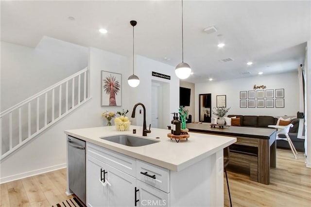 4085 E Liliana Paseo Unit 69, Ontario, CA 91764 - kitchen featuring a sink, dishwasher, open floor plan, light wood-style flooring, and a kitchen island with sink