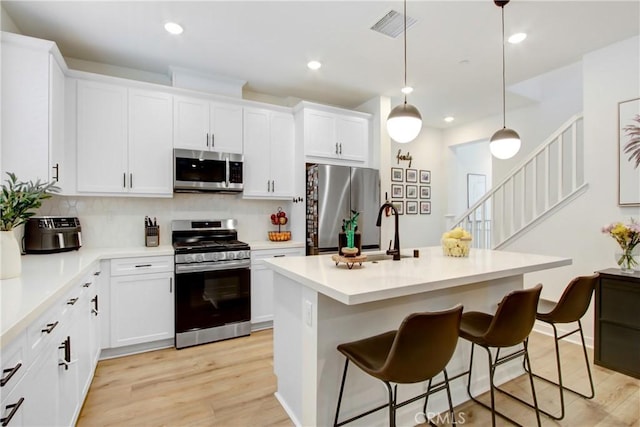 4085 E Liliana Paseo Unit 69, Ontario, CA 91764 - kitchen featuring stainless steel appliances, a sink, decorative backsplash, light wood-style flooring, and recessed lighting