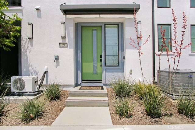 4085 E Liliana Paseo Unit 69, Ontario, CA 91764 - doorway to property with ac unit, stucco siding, and central AC