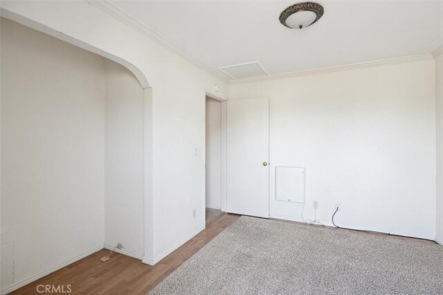 391 Sequoia St Unit 5, Morro Bay, CA 93442 - unfurnished room featuring wood finished floors, crown molding, baseboards, and arched walkways