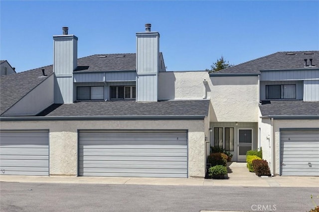 391 Sequoia St Unit 5, Morro Bay, CA 93442 - townhome / multi-family property featuring a chimney, a garage, a shingled roof, and stucco siding