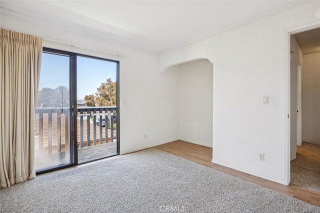 391 Sequoia St Unit 5, Morro Bay, CA 93442 - spare room featuring ornamental molding, wood finished floors, arched walkways, and baseboards