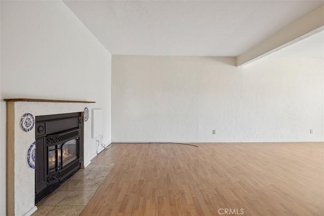 391 Sequoia St Unit 5, Morro Bay, CA 93442 - unfurnished living room with wood finished floors, a fireplace with flush hearth, and baseboards