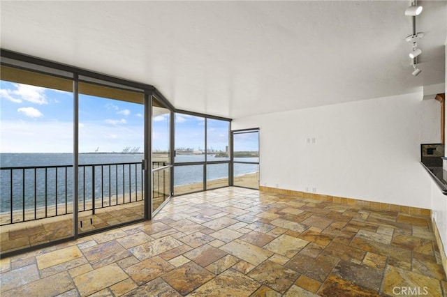 1750 E Ocean Blvd Unit 511, Long Beach, CA 90802 - unfurnished sunroom with a water view, stone tile floors, baseboards, and expansive windows