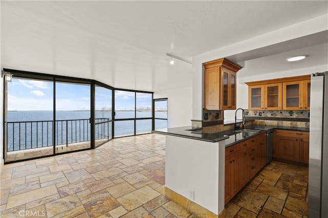 1750 E Ocean Blvd Unit 511, Long Beach, CA 90802 - kitchen featuring a sink, dishwasher, stone tile flooring, and brown cabinetry