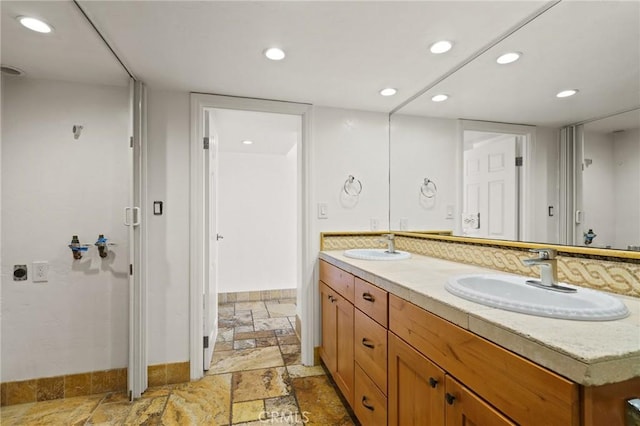 1750 E Ocean Blvd Unit 511, Long Beach, CA 90802 - bathroom with stone tile flooring, baseboards, double vanity, and recessed lighting