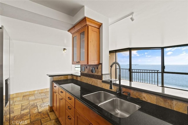1750 E Ocean Blvd Unit 511, Long Beach, CA 90802 - kitchen with a sink, stone tile flooring, brown cabinets, and a water view
