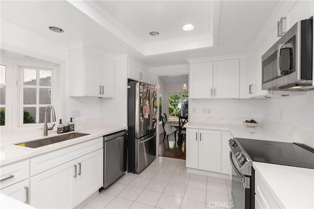 18 Blazing Star, Irvine, CA 92604 - kitchen with stainless steel appliances, a sink, light tile patterned floors, white cabinetry, and light countertops