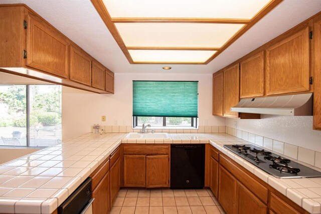 2432 Live Oak Rd, Escondido, CA 92029 - kitchen featuring black dishwasher, a sink, under cabinet range hood, gas stovetop, and tile countertops