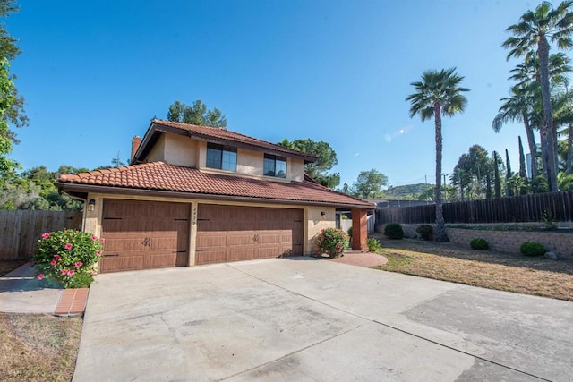 2432 Live Oak Rd, Escondido, CA 92029 - mediterranean / spanish-style house with a tile roof, concrete driveway, stucco siding, and a garage