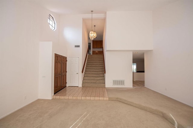 2432 Live Oak Rd, Escondido, CA 92029 - stairway featuring carpet flooring, a towering ceiling, plenty of natural light, a chandelier, and baseboards