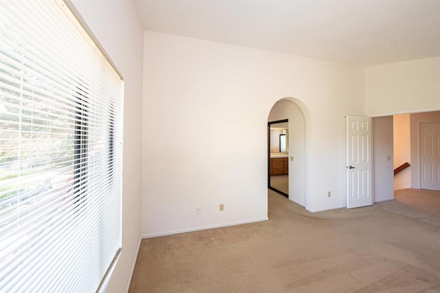 2432 Live Oak Rd, Escondido, CA 92029 - unfurnished bedroom featuring light colored carpet, arched walkways, and baseboards