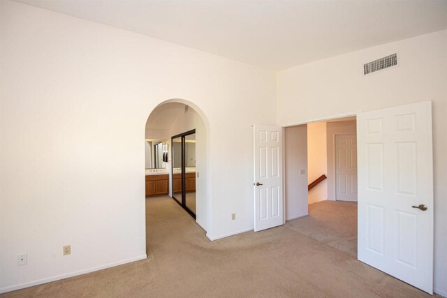 2432 Live Oak Rd, Escondido, CA 92029 - spare room featuring arched walkways, light colored carpet, and baseboards