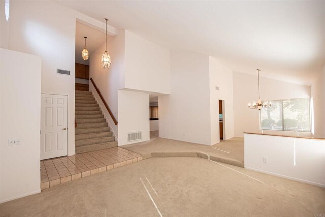 2432 Live Oak Rd, Escondido, CA 92029 - unfurnished living room with light carpet, high vaulted ceiling, a chandelier, and stairs